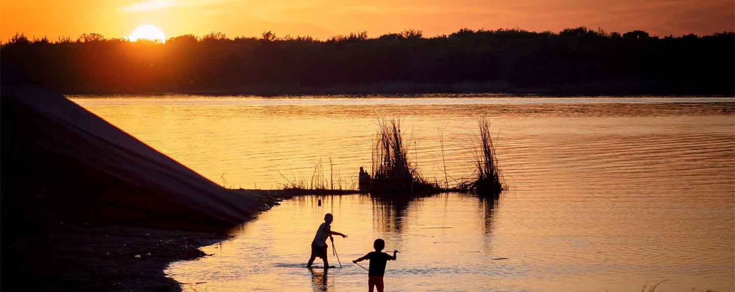 Two children playing in Lake Murray, while camping in Ardmore, OK